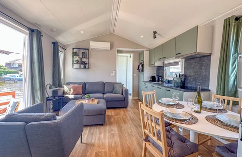 Municipality of Stichtse Vecht Boat Rental | Air-conditioned chalet with a waterside terrace