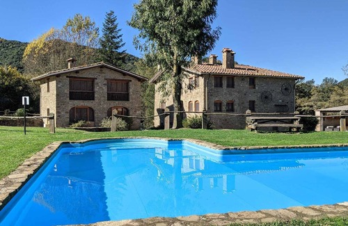 Santa Pau Apartment | Apartment 'Mas El Carrer - Blanc' with Shared Pool, Shared Garden and Wi-Fi