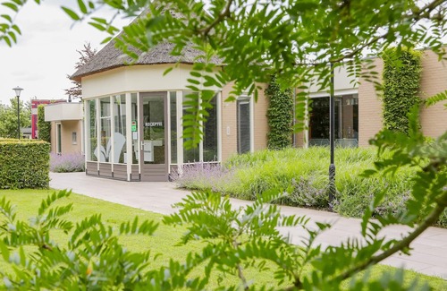 Municipality of Veldhoven Ski Chalet | Chalet by Pond in Eindhoven Holiday Park