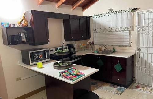 Old Harbour House | Charming gated 2-bedroom house with WiFi, AC, and spacious yard