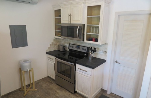 Double Bay Cottage | Cozy stone studio cottage on private pink sand beach