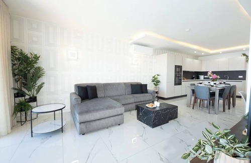 Qawra Apartment | Elegant seaview apartment in the heart of Bugibba. Enjoy modern design, a cozy bedroom, and a bright living area with a private terrace overlooking the Mediterranean — perfect for a relaxing coastal getaway