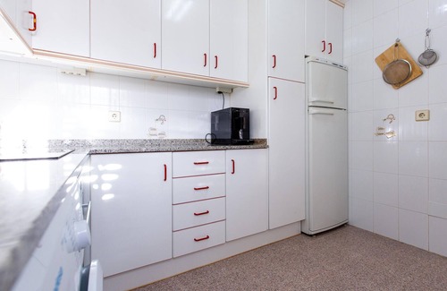 Los Puertos Apartment | Enjoy a relaxing vacation by the sea in this vacation apartment with a beautiful conservatory.