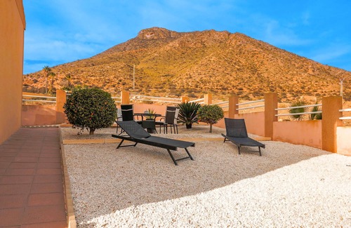 Los Puertos Apartment | Enjoy a relaxing vacation by the sea in this vacation apartment with a beautiful conservatory.