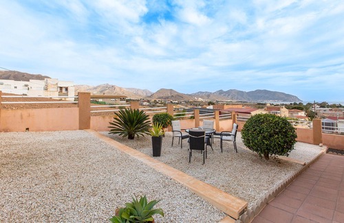 Los Puertos Apartment | Enjoy a relaxing vacation by the sea in this vacation apartment with a beautiful conservatory.