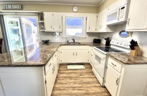 Avalon House | ENJOY BAY VIEWS! Bayfront home, shady front porch 2 boat docking areas, gameroom to watch TV, A short bike ride or walk to Avalon's fine business district for ice cream, dining, mini golf, shopping and more.