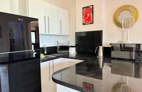 Village Road Apartment | G.3.11 Red Seafront apartment. Restaurant on beach, lounge chairs, umbrellas