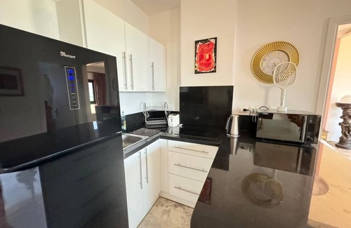 Village Road Apartment | G.3.11 Red Seafront apartment. Restaurant on beach, lounge chairs, umbrellas