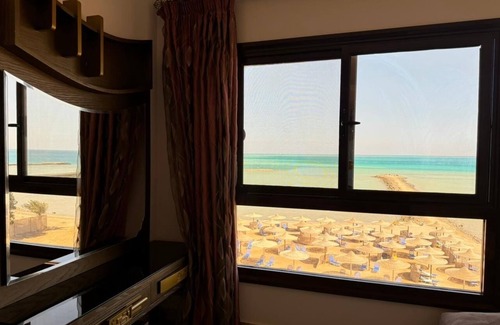 Village Road Apartment | G.3.11 Red Seafront apartment. Restaurant on beach, lounge chairs, umbrellas