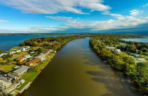 Dora Creek Villa | Lake Palm Retreat - shared pool and waterfront
