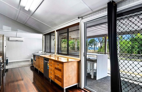 Urangan House | Large Waterfront Home With Pool - CoastHM