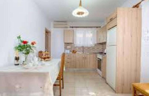 Longos Apartment | Located in the most enviable position, with uninterrupted views of Loggos Harbour and the sea, sits