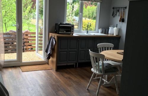 Sandy Lane Cabin | Lovely Wooden Lodge, views over an orchard, outside seating.