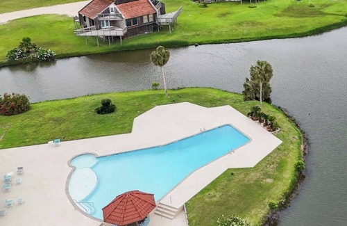 Matagorda Condo | Relax poolside with the whole family or hunt shells on the beach.