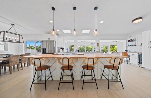 Venetian Way House | Remodeled Riverfront Pool and Dock Home in the Heart of Cocoa Beach.