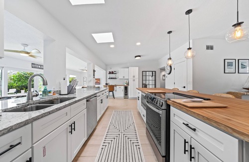 Venetian Way House | Remodeled Riverfront Pool and Dock Home in the Heart of Cocoa Beach.