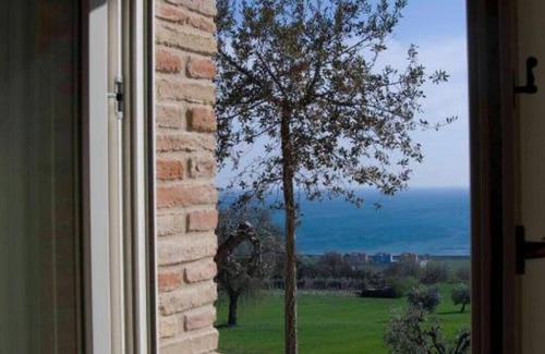 Potenza Picena Villa | Resort surrounded by greenery arranged for families or groups with an infinity pool.