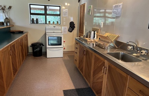 Western Lake Cabin | Rustic cabin & large kitchen block nestled in a native garden.