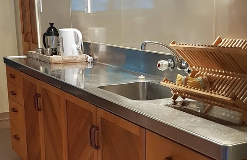 Western Lake Cabin | Rustic cabin & large kitchen block nestled in a native garden.