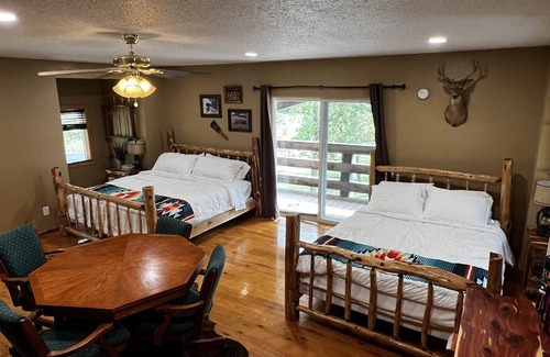Wyandotte Cabin | Rustic Lodge with a view of open pastures and bison grazing on the land.