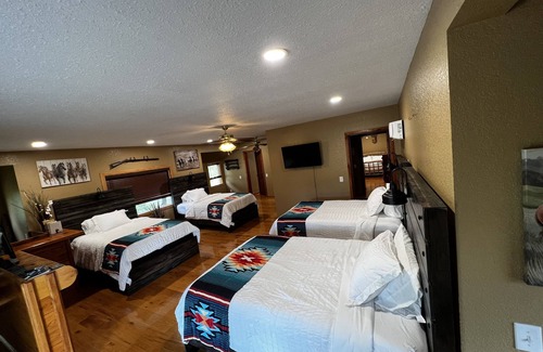 Wyandotte Cabin | Rustic Lodge with a view of open pastures and bison grazing on the land.