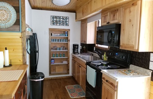 Upper Peachtree Cabin | Rustic two-story cabin on creek with covered bridge and water wheel.