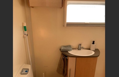 Whakatiwai House | Seabird Coast Retreat - Modern caravan located in orchard on waterfront property