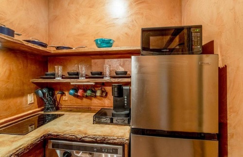 Virgin RV Rental | Serene Cliff Dwelling - King Bed, Hot Tub, and BBQ