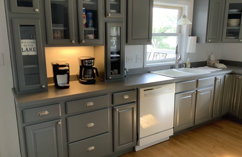 Channel Lake House | Serene lakefront house with expansive deck and pier