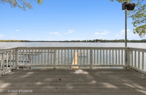 Channel Lake House | Serene lakefront house with expansive deck and pier