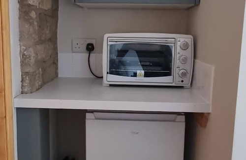 Church Knowle Apartment | The Old Post Office, annex with bedroom, onsuite and lounge with kitchenette.