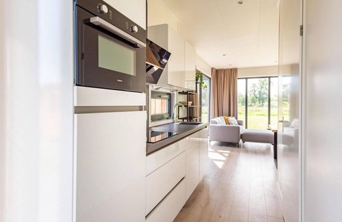 Kotten House | This holiday home for 6 people has a spacious living room with an open kitchen, three bedrooms, and a spacious terrace.