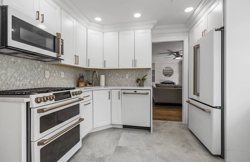 Oakdale House | Updated home with canal & hot tub in backyard. Close to everything!