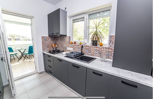 Tunari House | Welcome to GardenHideaway! Cozy stay with new furniture in a serene setting.