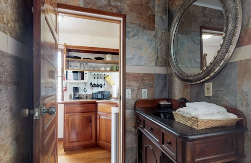 Hopkins Apartment | Wood cabana with a porch, pool view, WiFi, and a shared common area with grills