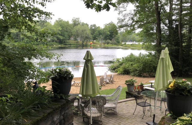 Light, airy, comfy, casual, wooded, lakefront home with private sandy beach