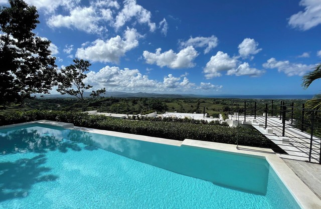 Luxurious villa set in a vast tropical garden, with panoramic sea and nature views.