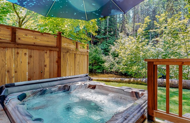 Rare, dog-friendly riverfront retreat with hot tub access plus kayaks & AC