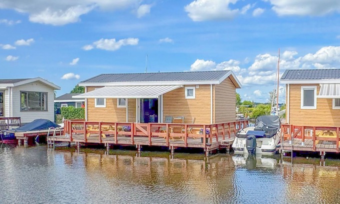 Municipality of Stichtse Vecht Boat Rental | Air-conditioned chalet with a waterside terrace