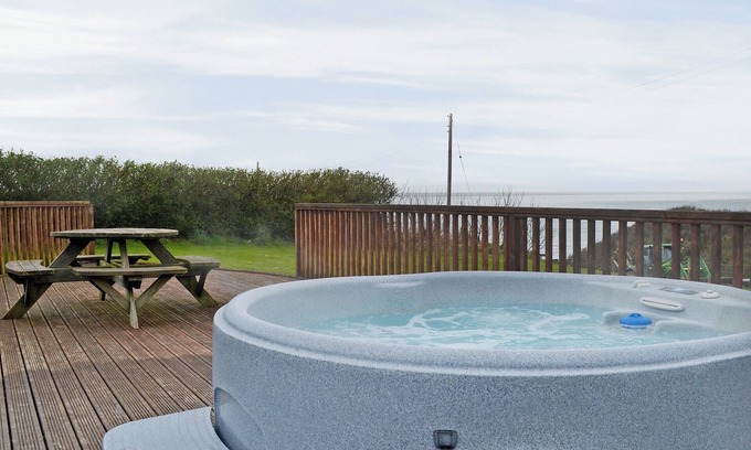 Garn Fadryn Cottage | Relax and unwind in the blissful, private hot tub.