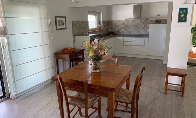 Ragogna Apartment | River house surrounded by greenery.