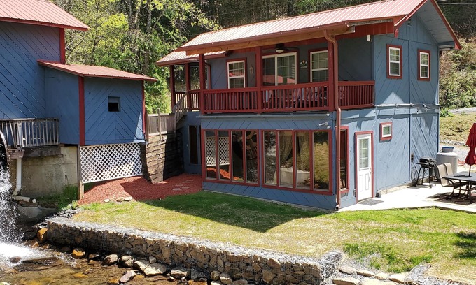 Upper Peachtree Cabin | Rustic two-story cabin on creek with covered bridge and water wheel.