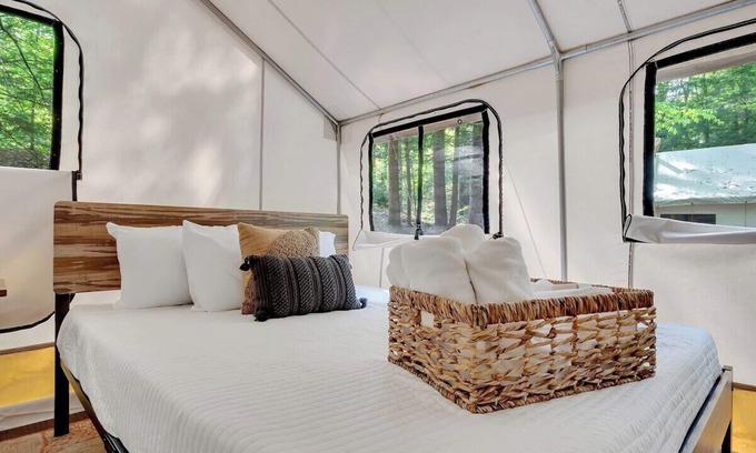 Middle Grove RV Rental | Unplug in comfort—glamping tent with real beds, electricity, fire ring, bathhouse, and nearby pond.