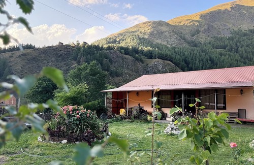 Kazbegi House | A Private Guest House in a secluded area by the river, surrounded by mountains.