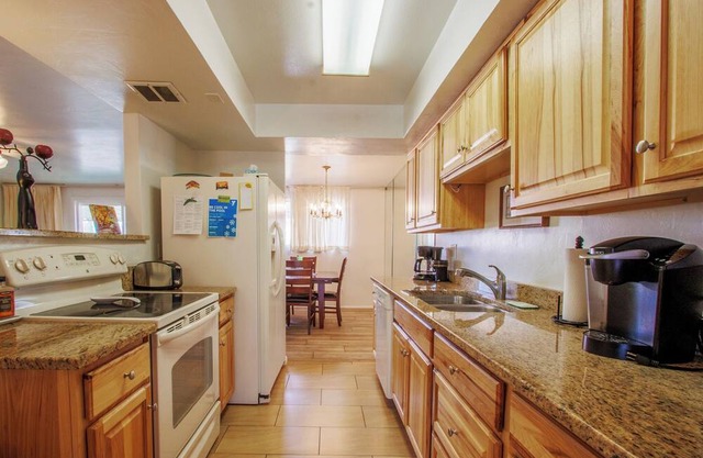 Charming 2-bedroom townhome, 2 car carport, open DR, LR, Kitchen, Patio, Pool