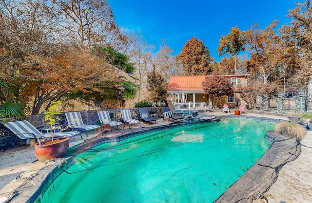 Unique and retro stay on the river with grill, hot tub, pool, & W/D access